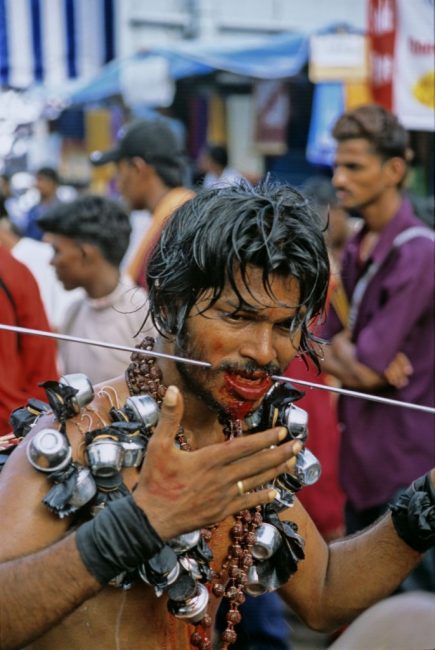 Thaipusam pilgram puts spike through cheek