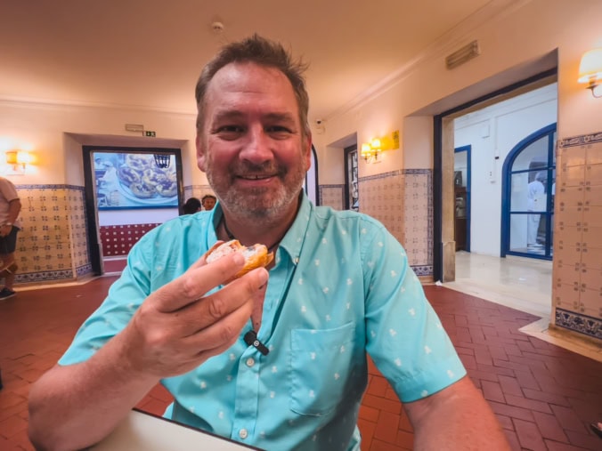 Dave from The Planet D eating a Pastel De Nata inn Lisbon