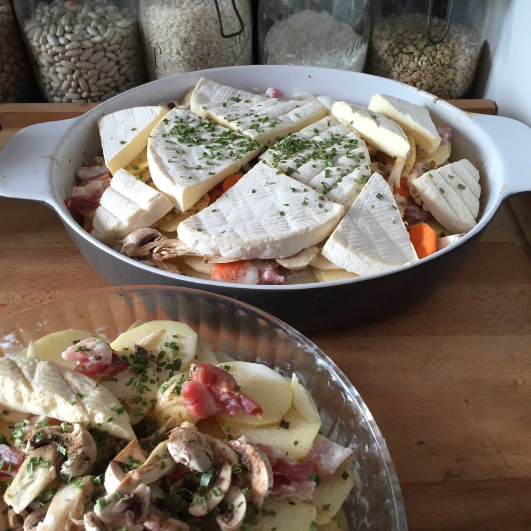A bubbling, golden-brown tartiflette, a French alpine dish of potatoes, bacon, and Reblochon cheese