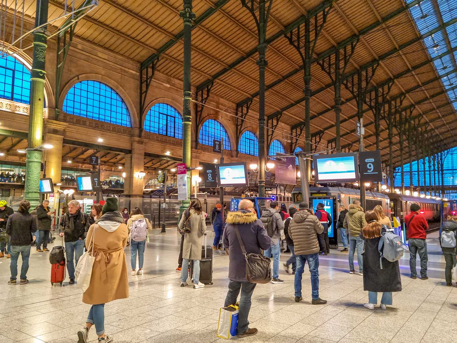 People walking in the platforms of the Gare du Nord station in Paris