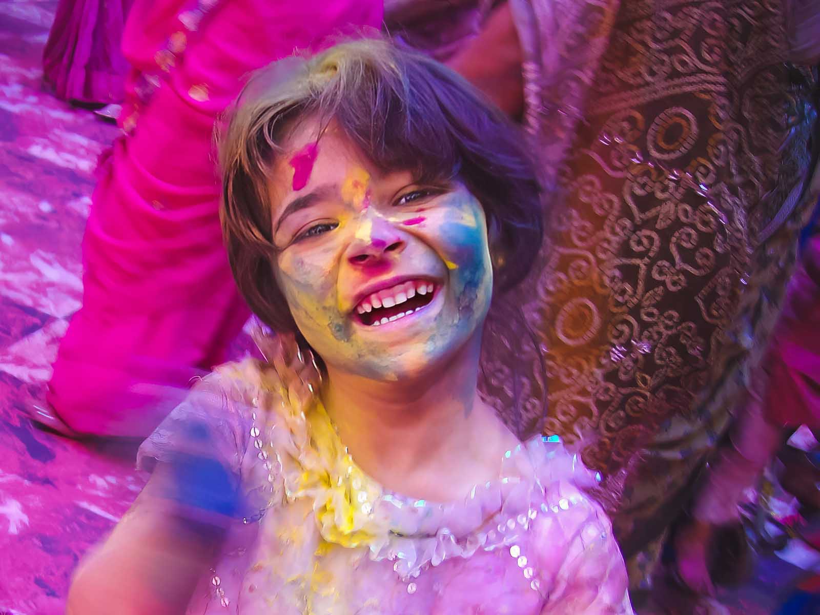 child smiling during holi india