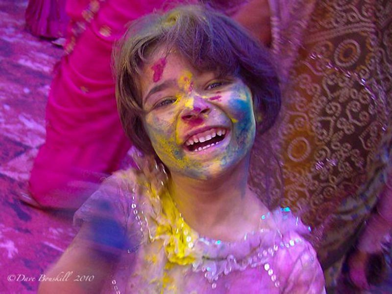 child smiling during holi india