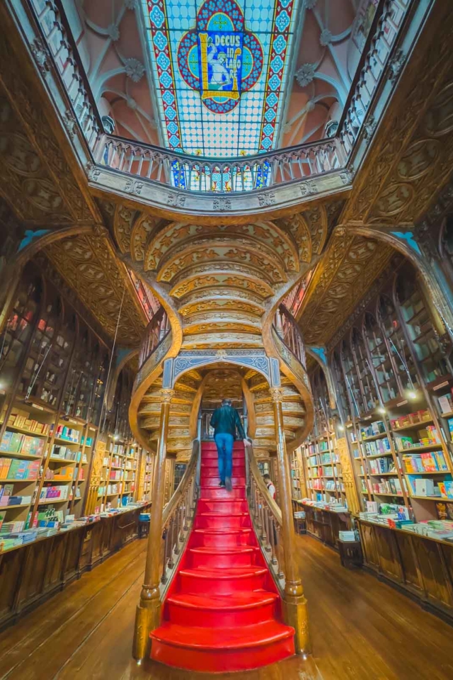 stained-glass skylight and majestic staircase at Livraria Lello