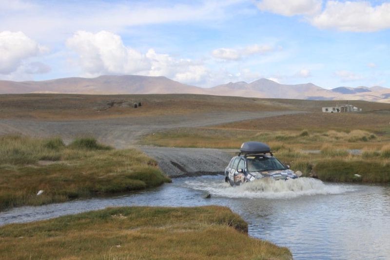 mongo rally car driving through river