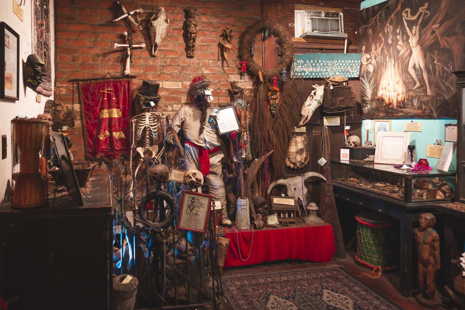 museums to visit in new orleans - Voodoo Museum interior with masks and skulls on display