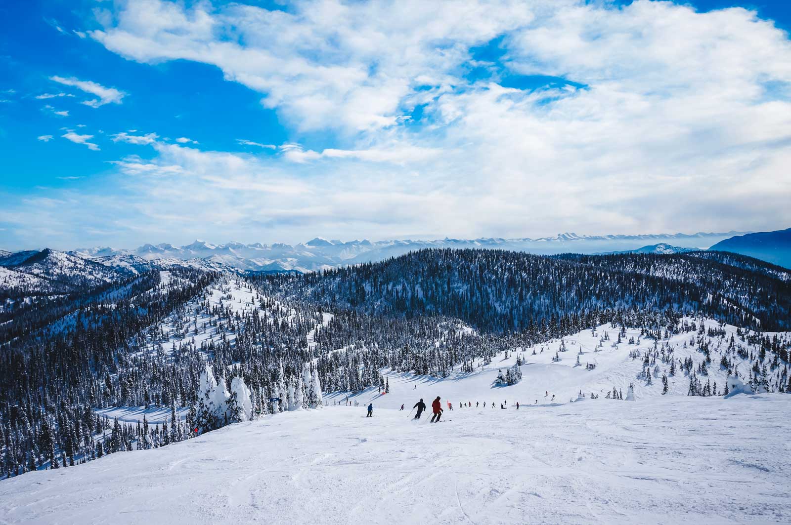21 Best Places to Visit in December in the USA (2025 Edition) A person snowshoeing on a trail in Glacier National Park near Whitefish, Montana, a great December adventure.