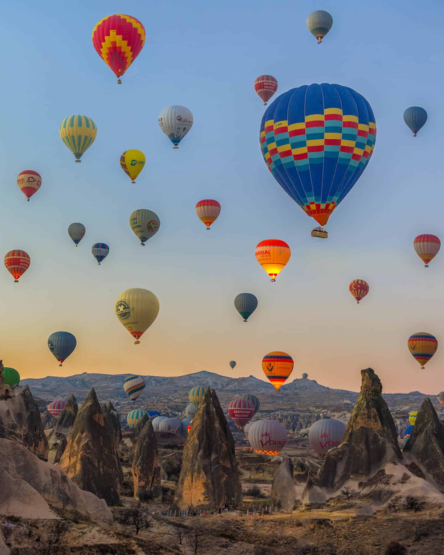 cappadocia turkey hot air baloons over fairy chimneys