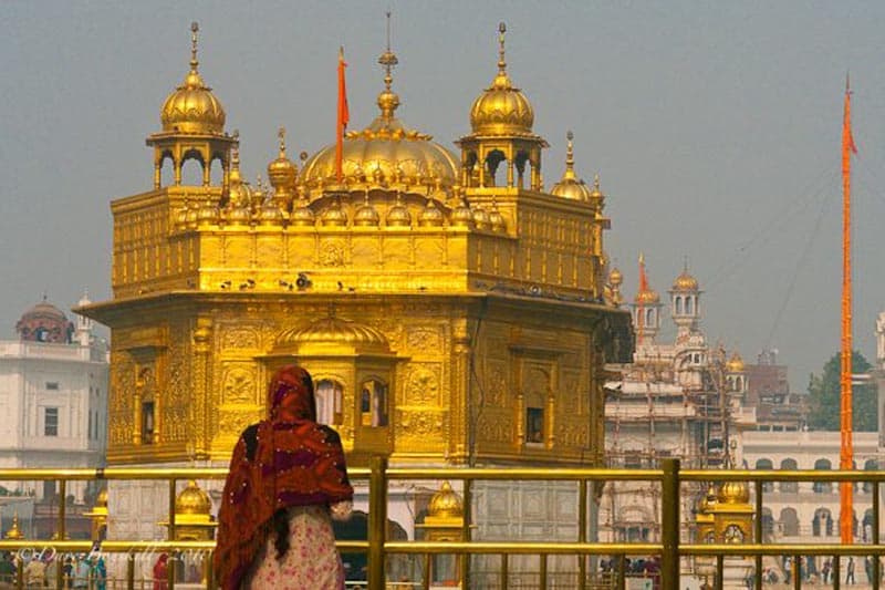 woman looking at gold temple