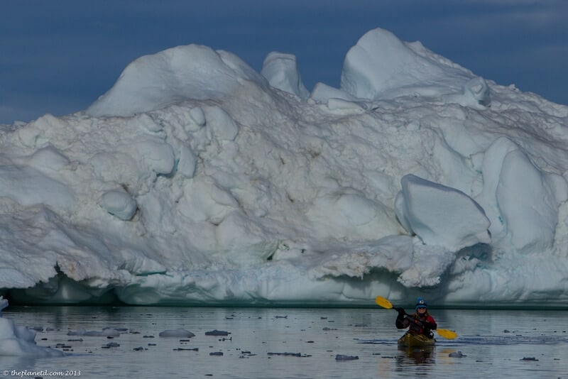 kayaking in Greenland Deb near large iceberg