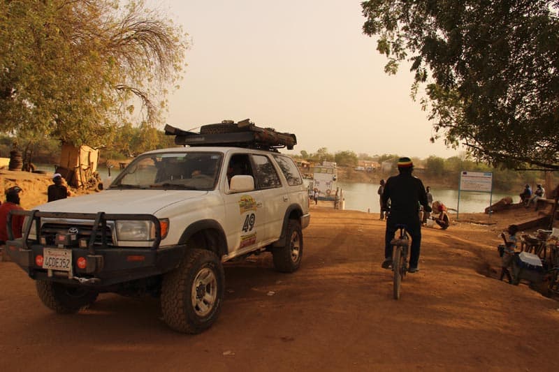 bamako rally cyclist beside overland truck