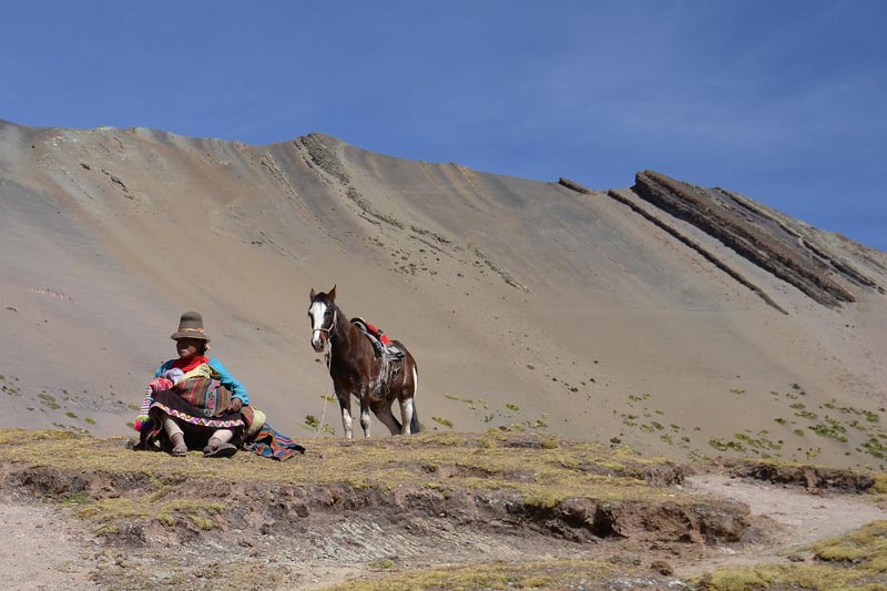 peru man with horse on our trek up Rainbow Mountain