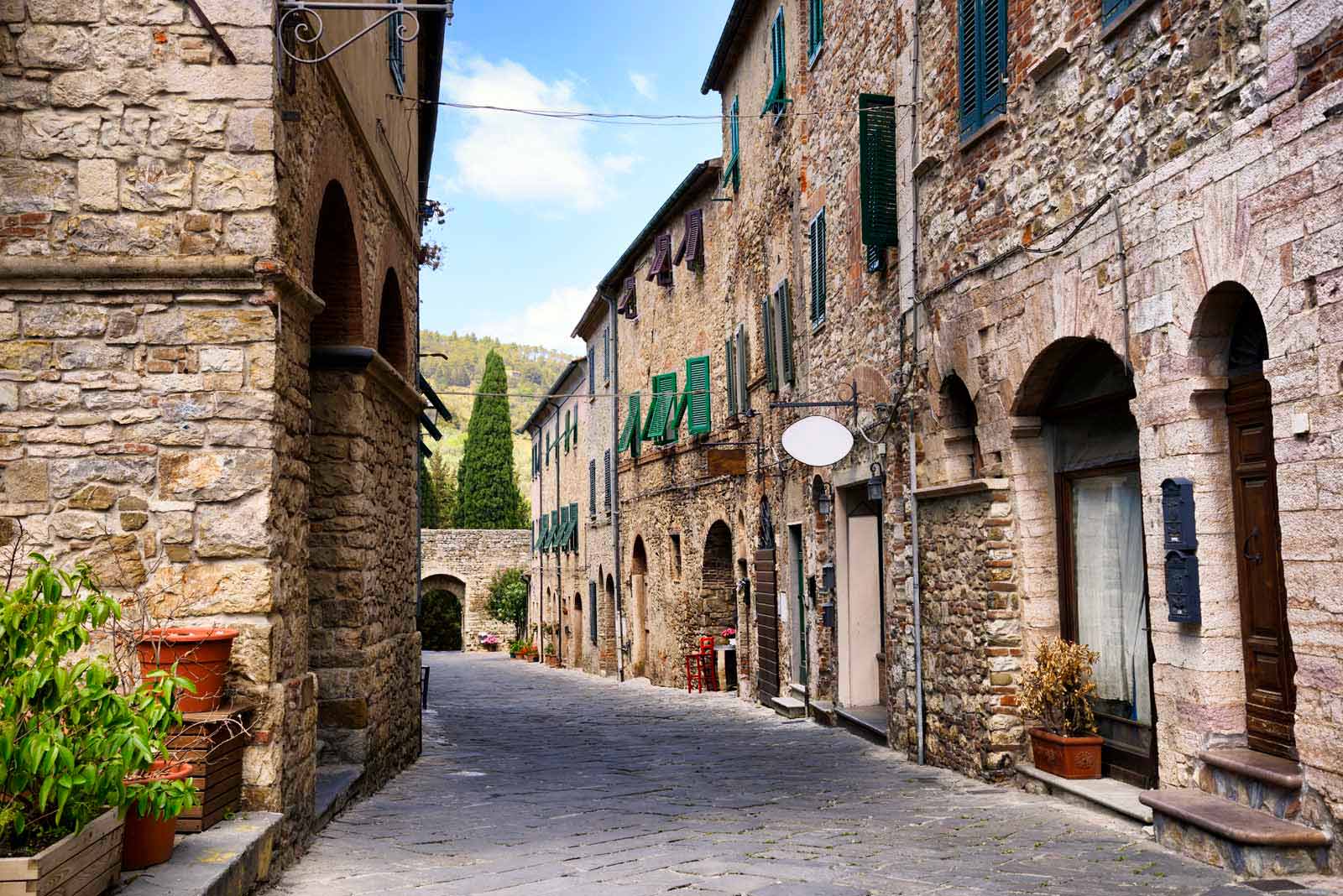 towns in tuscany cobblestone street 