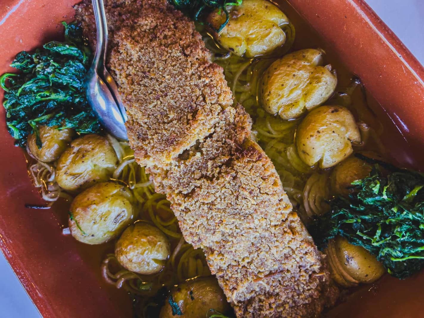 traditional Portuguese food Bacalhau served with potatoes in a restaurant in Lisbon.