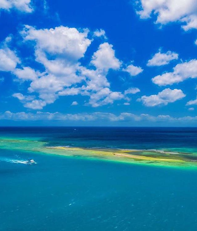 tropical destinations aruba boat in blue water