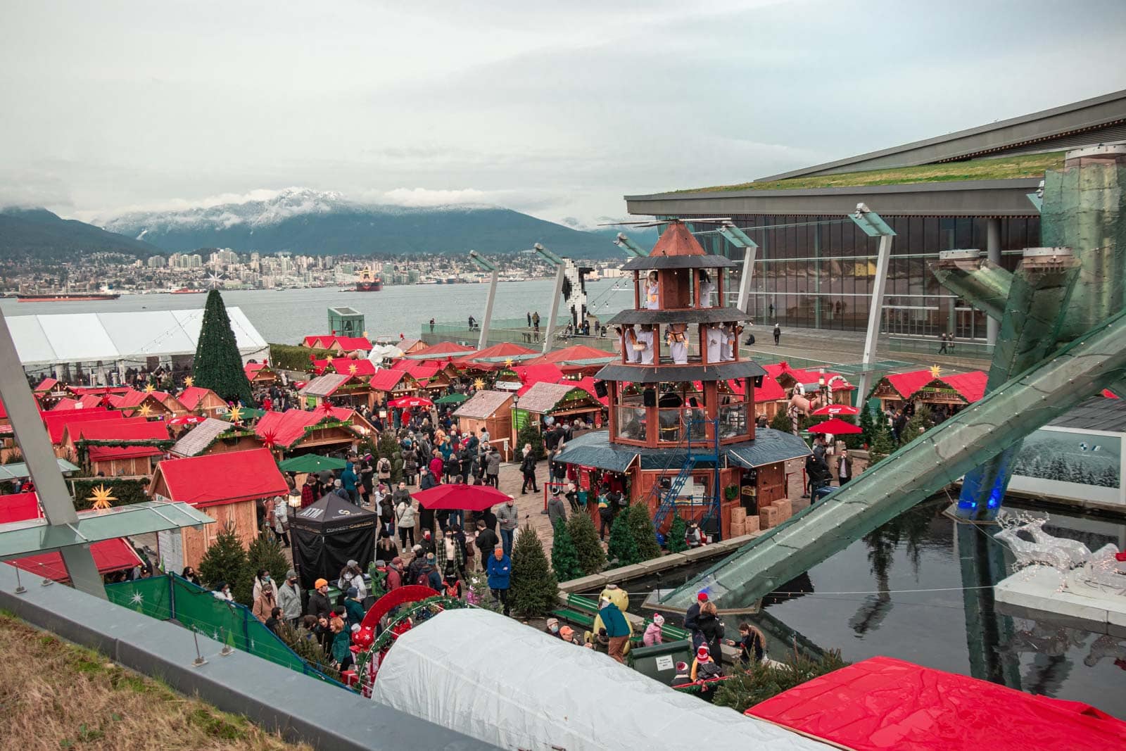 Wooden stalls adorned with festive lights at the Vancouver Christmas Market.