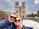 Dave and Deb from The Planet D in front of Notre Dame, figuring out the best area where to stay in Paris for a first visit.
