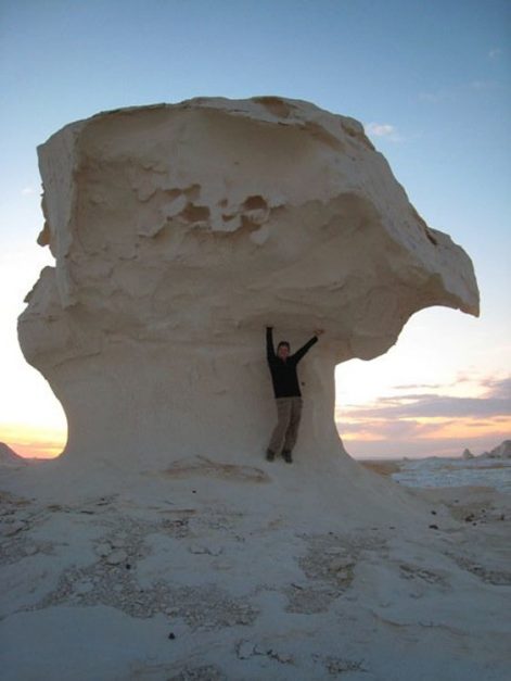deb standing under massive white desert formation